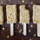 Four Banana Pudding Pops on wooden surface